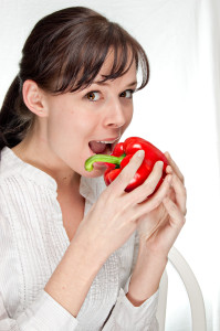 woman eating red capsicum