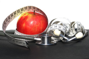 apple with stethoscope and measuring tape