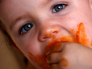 baby pasta face hand in mouth