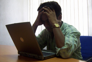 stressed man with laptop