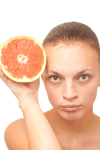 woman holding grapefruit
